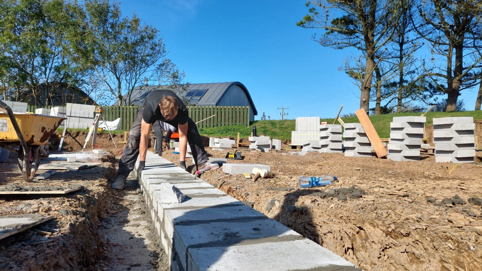 Builder laying masonry during a North Cornwall construction project